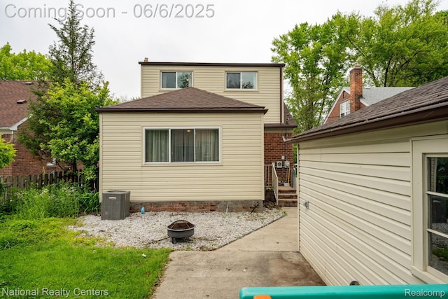 1395 Aline Dr, Grosse Pointe Woods, MI 48236 - rear view of house with an outdoor fire pit, central AC unit, and roof with shingles