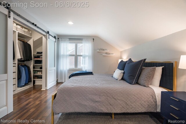 1395 Aline Dr, Grosse Pointe Woods, MI 48236 - bedroom with a barn door, a walk in closet, vaulted ceiling, wood finished floors, and a closet
