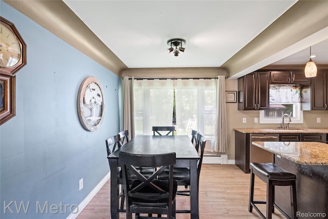 3191 Perry Ct, Grand Blanc, MI 48439 - dining area featuring light wood-type flooring, a baseboard radiator, and baseboards