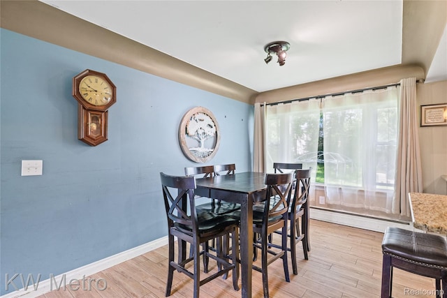 3191 Perry Ct, Grand Blanc, MI 48439 - dining space featuring a baseboard radiator, light wood-style flooring, and baseboards