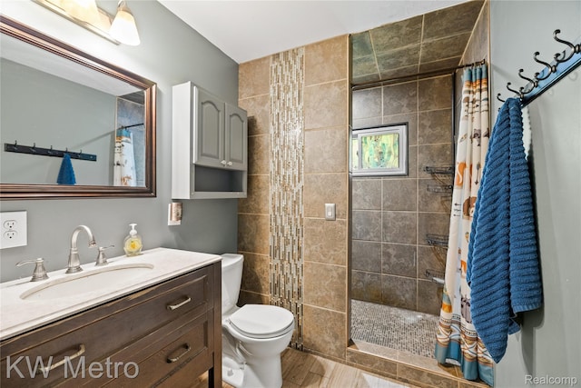 3191 Perry Ct, Grand Blanc, MI 48439 - bathroom with toilet, vanity, a tile shower, and wood finished floors