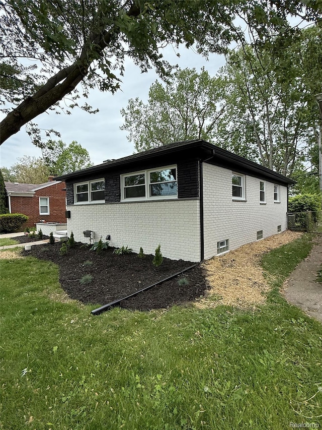 20218 Chalon St, Saint Clair Shores, MI 48080 - view of side of property with brick siding and a lawn