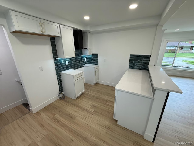 20218 Chalon St, Saint Clair Shores, MI 48080 - kitchen with a peninsula, decorative backsplash, light wood-type flooring, light countertops, and recessed lighting