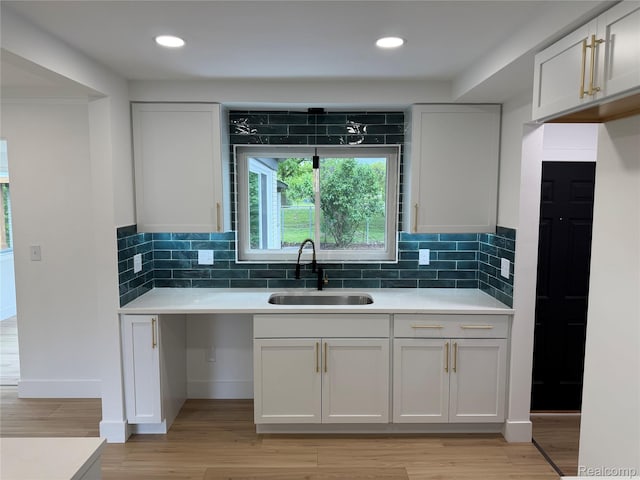 20218 Chalon St, Saint Clair Shores, MI 48080 - kitchen featuring a sink, light countertops, light wood-style floors, tasteful backsplash, and recessed lighting
