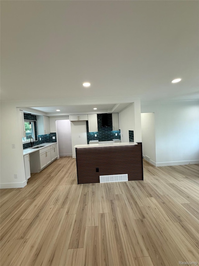 20218 Chalon St, Saint Clair Shores, MI 48080 - kitchen featuring tasteful backsplash, open floor plan, light countertops, a peninsula, and baseboards