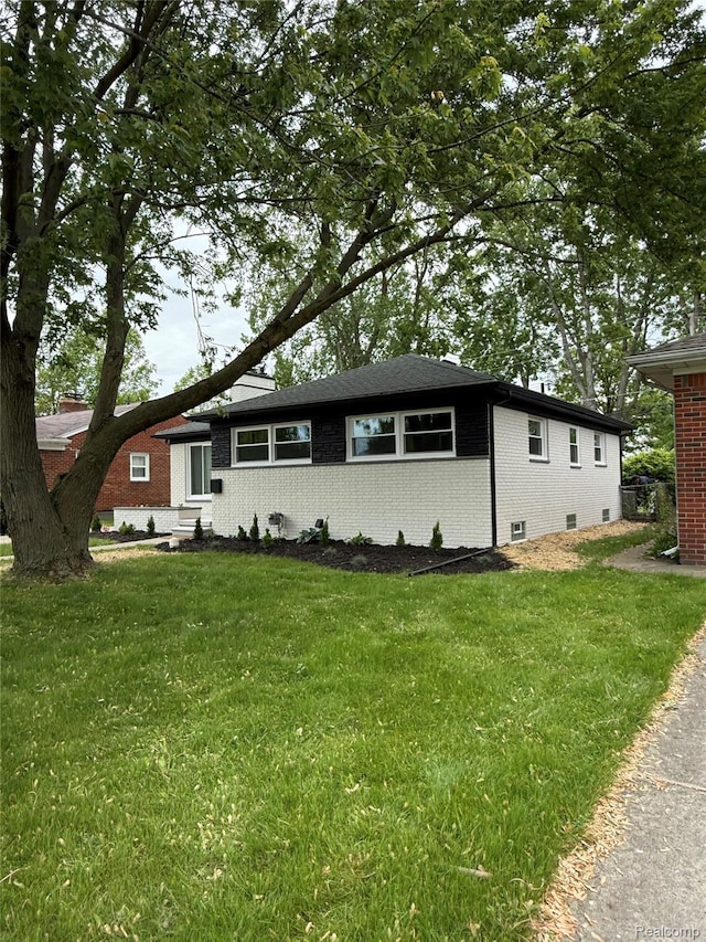 20218 Chalon St, Saint Clair Shores, MI 48080 - view of front facade featuring entry steps, brick siding, and a front yard