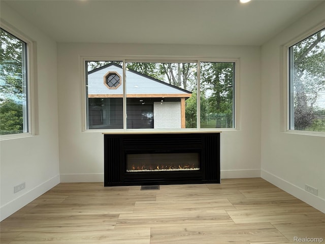 20218 Chalon St, Saint Clair Shores, MI 48080 - detailed view of baseboards, a glass covered fireplace, recessed lighting, and wood finished floors