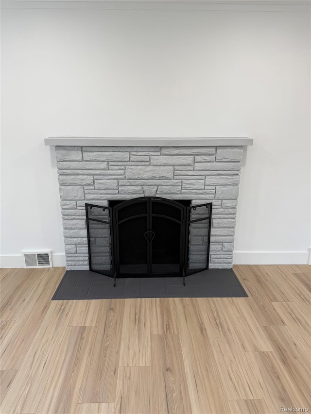 20218 Chalon St, Saint Clair Shores, MI 48080 - detailed view of a stone fireplace, baseboards, and wood finished floors