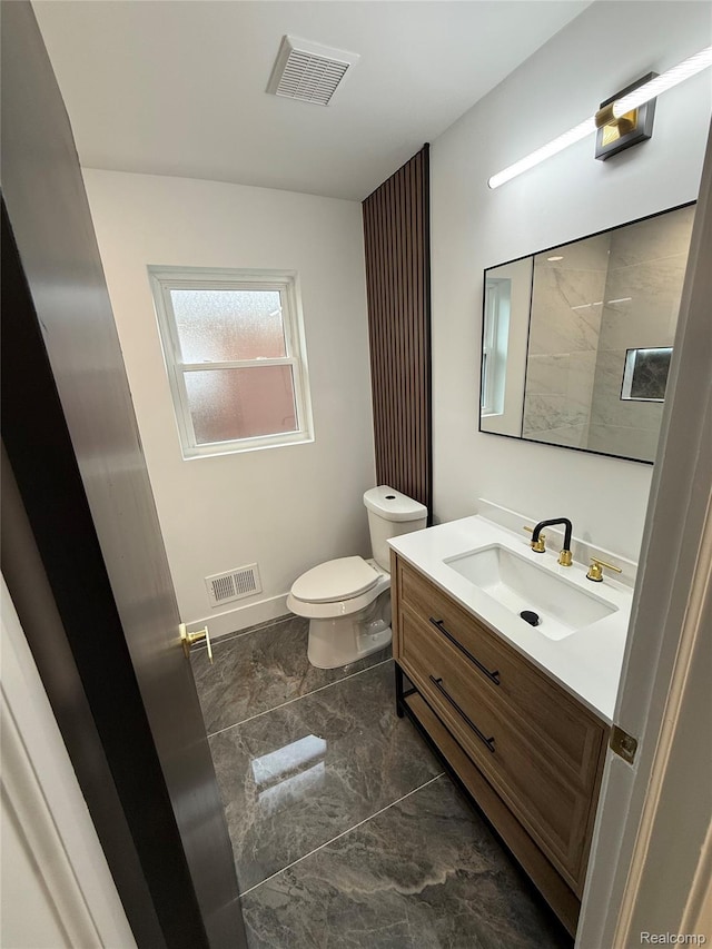20218 Chalon St, Saint Clair Shores, MI 48080 - bathroom with marble look tile flooring, vanity, toilet, and baseboards