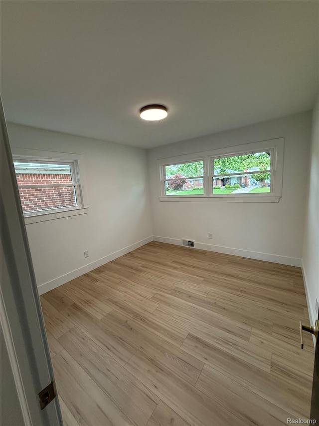 20218 Chalon St, Saint Clair Shores, MI 48080 - spare room featuring light wood-style floors, plenty of natural light, and baseboards