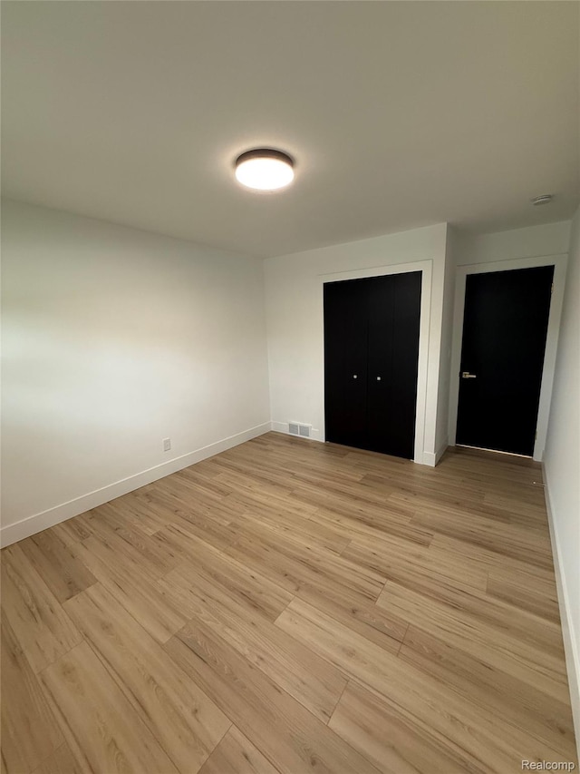 20218 Chalon St, Saint Clair Shores, MI 48080 - unfurnished bedroom with light wood-style floors, baseboards, and a closet