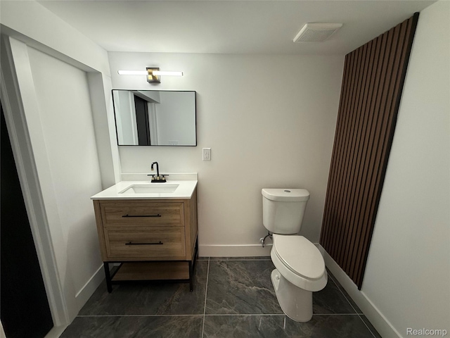 20218 Chalon St, Saint Clair Shores, MI 48080 - bathroom with toilet, vanity, baseboards, and tile patterned floors