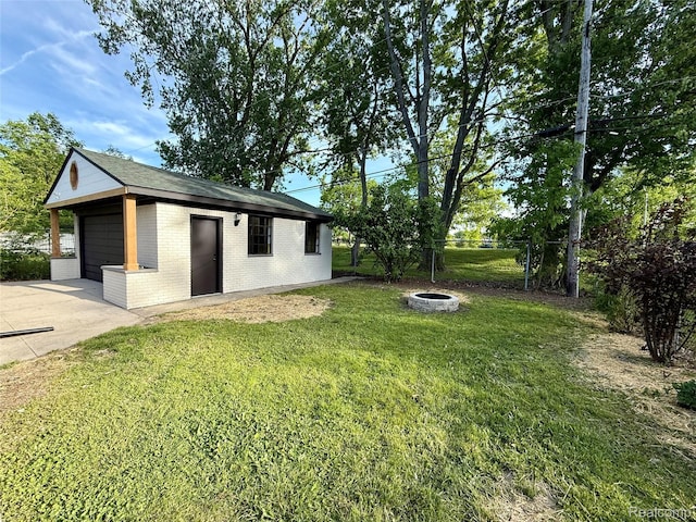 20218 Chalon St, Saint Clair Shores, MI 48080 - view of yard with concrete driveway, an outdoor structure, and a fire pit
