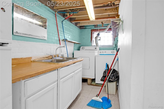 2393 Burger St, Hamtramck, MI 48212 - laundry room featuring independent washer and dryer, cabinet space, and light flooring