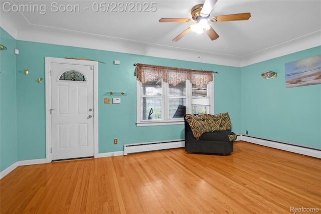 2393 Burger St, Hamtramck, MI 48212 - living area featuring a baseboard heating unit, wood finished floors, ceiling fan, and baseboards