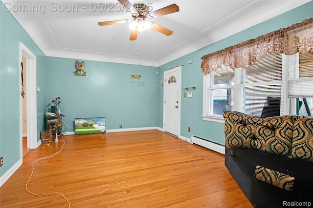 2393 Burger St, Hamtramck, MI 48212 - entrance foyer featuring a baseboard radiator, wood finished floors, ceiling fan, and baseboards