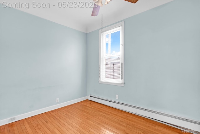 2393 Burger St, Hamtramck, MI 48212 - empty room featuring a baseboard heating unit, a ceiling fan, light wood-style flooring, and baseboards