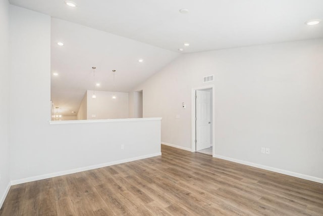 637 Manorwood Cir, Benton Harbor, MI 49022 - empty room with vaulted ceiling, wood finished floors, baseboards, and recessed lighting