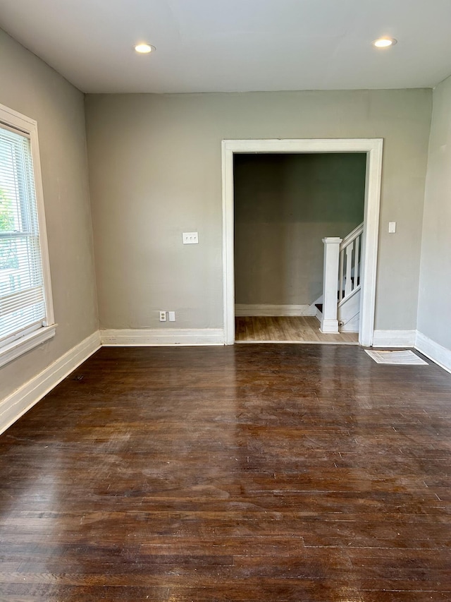 2927 Seyburn St, Detroit, MI 48214 - empty room with dark wood-style flooring, stairs, baseboards, and recessed lighting