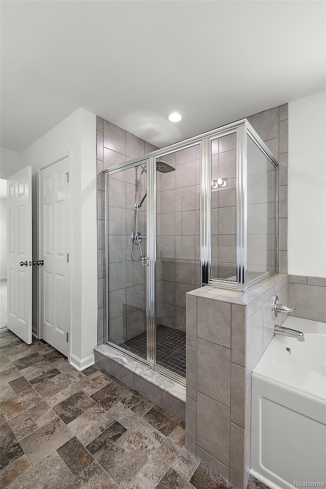 24603 Beach Dr, Macomb, MI 48042 - full bath with a stall shower, a bath, stone tile flooring, recessed lighting, and baseboards