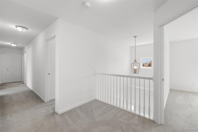 24603 Beach Dr, Macomb, MI 48042 - hallway with carpet floors, a chandelier, baseboards, and an upstairs landing