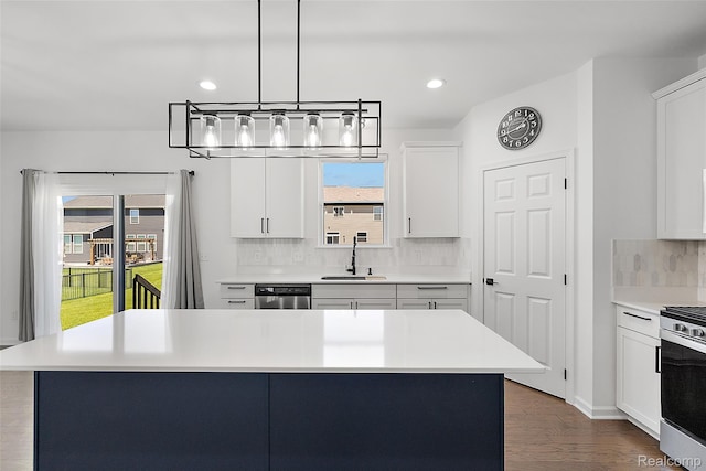 24603 Beach Dr, Macomb, MI 48042 - kitchen with a sink, appliances with stainless steel finishes, backsplash, light countertops, and white cabinets