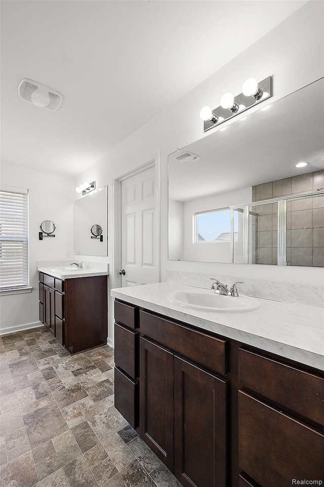 24603 Beach Dr, Macomb, MI 48042 - full bath featuring two vanities, a shower stall, and baseboards