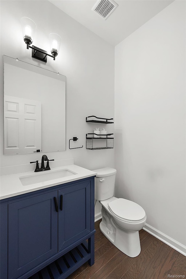 24603 Beach Dr, Macomb, MI 48042 - half bath featuring toilet, baseboards, wood finished floors, and vanity