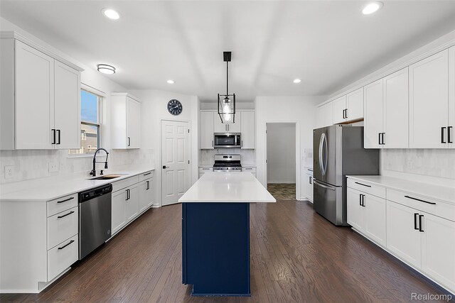 24603 Beach Dr, Macomb, MI 48042 - kitchen with appliances with stainless steel finishes, a sink, a center island, tasteful backsplash, and recessed lighting