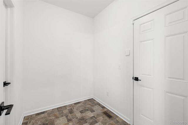 24603 Beach Dr, Macomb, MI 48042 - unfurnished room with baseboards and stone finish flooring