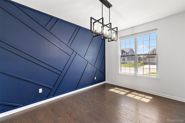 24603 Beach Dr, Macomb, MI 48042 - spare room featuring a chandelier, baseboards, and dark wood-style floors