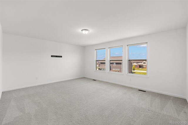 24603 Beach Dr, Macomb, MI 48042 - spare room featuring carpet flooring and baseboards