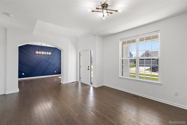 24603 Beach Dr, Macomb, MI 48042 - foyer entrance with a chandelier, hardwood / wood-style floors, arched walkways, and baseboards