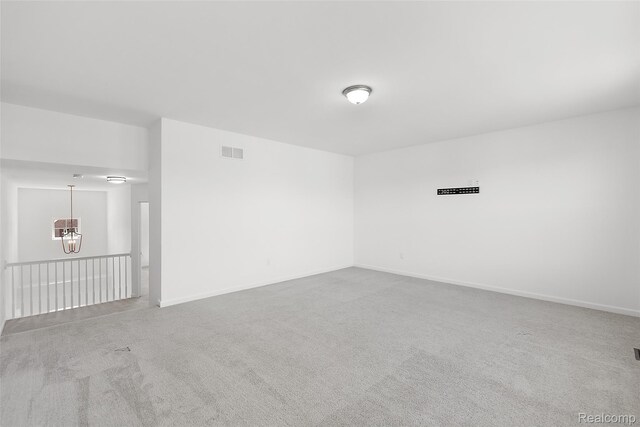 24603 Beach Dr, Macomb, MI 48042 - spare room with a chandelier, carpet flooring, and baseboards