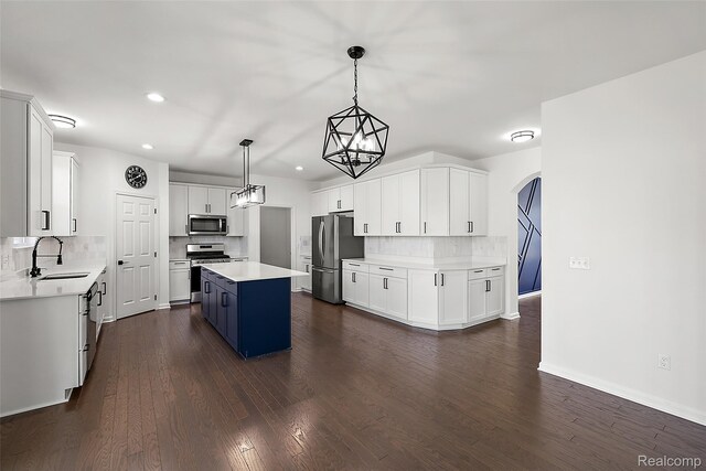 24603 Beach Dr, Macomb, MI 48042 - kitchen with a sink, appliances with stainless steel finishes, a kitchen island, backsplash, and recessed lighting