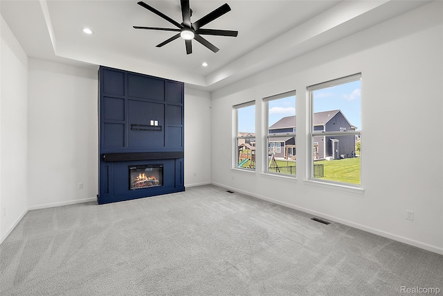 24603 Beach Dr, Macomb, MI 48042 - unfurnished living room featuring a raised ceiling, recessed lighting, carpet floors, and baseboards