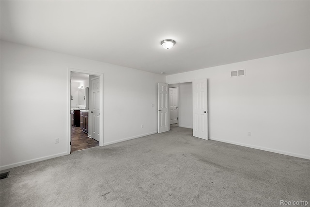 24603 Beach Dr, Macomb, MI 48042 - unfurnished bedroom with carpet, baseboards, and ensuite bathroom
