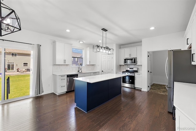 24603 Beach Dr, Macomb, MI 48042 - kitchen with stainless steel appliances, a kitchen island, a sink, decorative backsplash, and recessed lighting