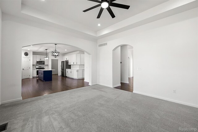 24603 Beach Dr, Macomb, MI 48042 - unfurnished living room featuring recessed lighting, a ceiling fan, a raised ceiling, baseboards, and dark carpet