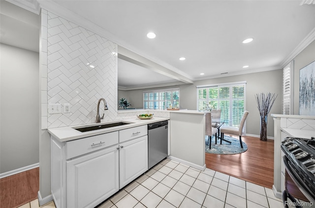 3553 Port Cove Dr Unit 39, Waterford, MI 48328 - kitchen with stainless steel appliances, a sink, light countertops, crown molding, and white cabinetry