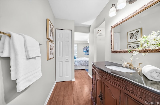 3553 Port Cove Dr Unit 39, Waterford, MI 48328 - ensuite bathroom featuring vanity, baseboards, and wood finished floors