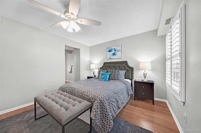 3553 Port Cove Dr Unit 39, Waterford, MI 48328 - bedroom with wood finished floors, baseboards, and ceiling fan
