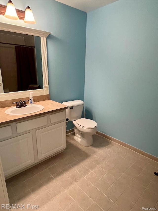 46117 Rhodes Dr Unit 298, Macomb, MI 48044 - bathroom with toilet, vanity, baseboards, tile patterned flooring, and curtained shower