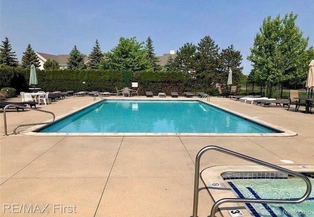 46117 Rhodes Dr Unit 298, Macomb, MI 48044 - community pool with a patio area