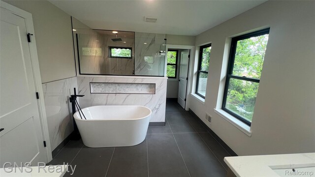 206 E Windemere Ave, Royal Oak, MI 48073 - full bath with a marble finish shower, a freestanding tub, tile patterned flooring, and vanity
