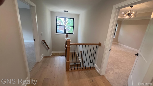 206 E Windemere Ave, Royal Oak, MI 48073 - hallway with an upstairs landing, a chandelier, light wood-type flooring, and baseboards
