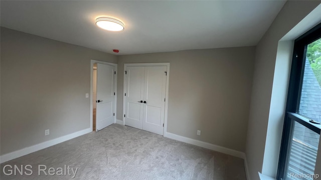 206 E Windemere Ave, Royal Oak, MI 48073 - unfurnished bedroom featuring carpet floors, baseboards, and a closet