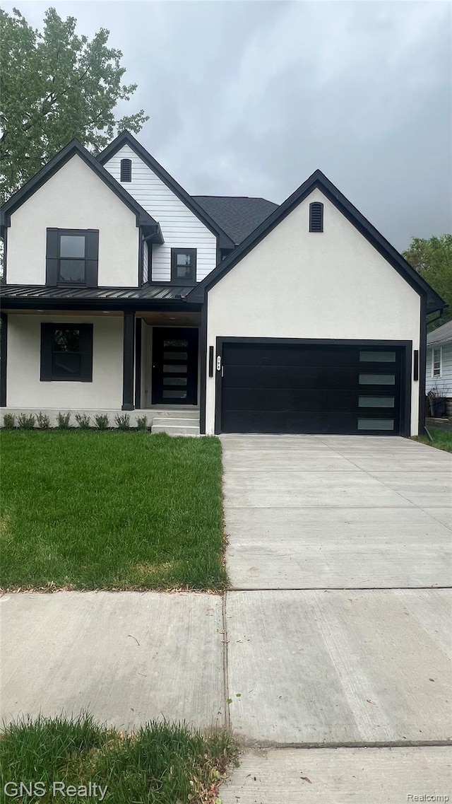 206 E Windemere Ave, Royal Oak, MI 48073 - view of front of house with stucco siding, a garage, concrete driveway, and a front yard