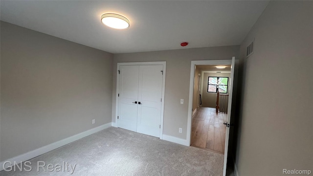 206 E Windemere Ave, Royal Oak, MI 48073 - unfurnished bedroom featuring carpet, baseboards, and a closet