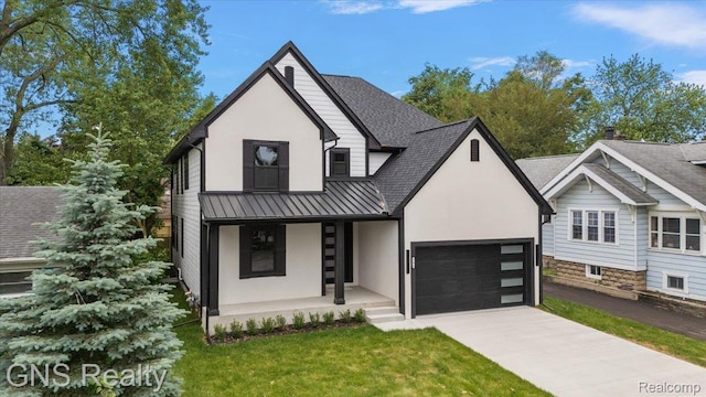 206 E Windemere Ave, Royal Oak, MI 48073 - view of front of property featuring a standing seam roof, a garage, a porch, driveway, and stucco siding